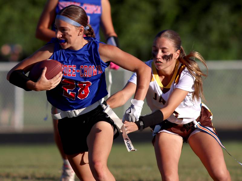 Dundee-Crown’s Kerrigan Svec, left, tries to get past Jacobs’ Ella Edgerton in varsity flag football on Tuesday, Sept. 3, 2024, at Dundee-Crown High School in Carpentersville.