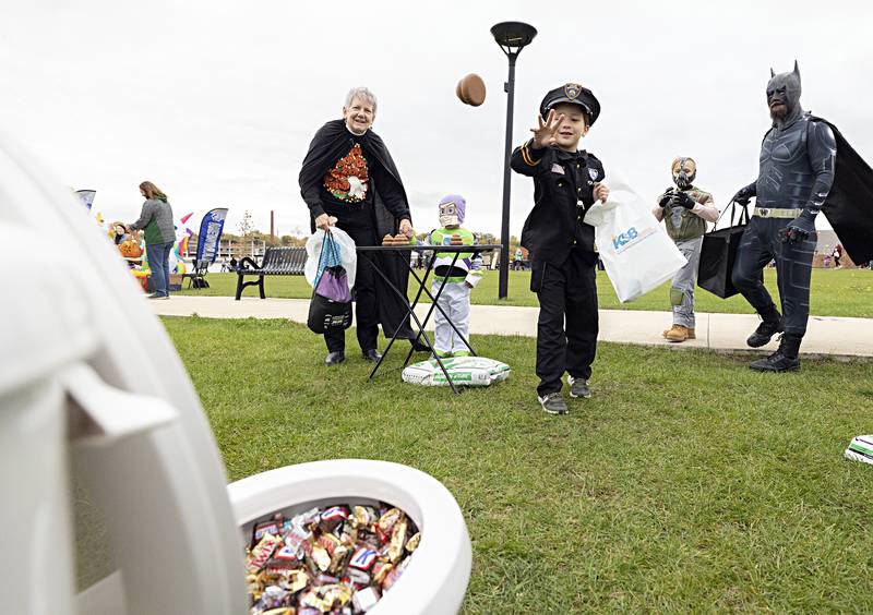 Kawai Tablante, 7, tosses a rubber toy towards a toilet bowl Friday, Oct. 27, 2023 doing Rock Falls’ Biz Boo trick-or-treat event. SPK Plumbing and Heating set up the whimsical booth for kids to try for candy at RB&W Park.