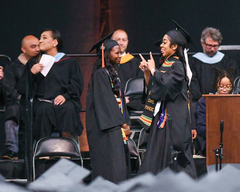 DeKalb High School senior Tannsia Dunn celebrates as she walks across stage to accept her diploma  during 2024 DeKalb High School commencement ceremony on Saturday, May 25, 2024, at the Northern Illinois University Convocation Center in DeKalb.
