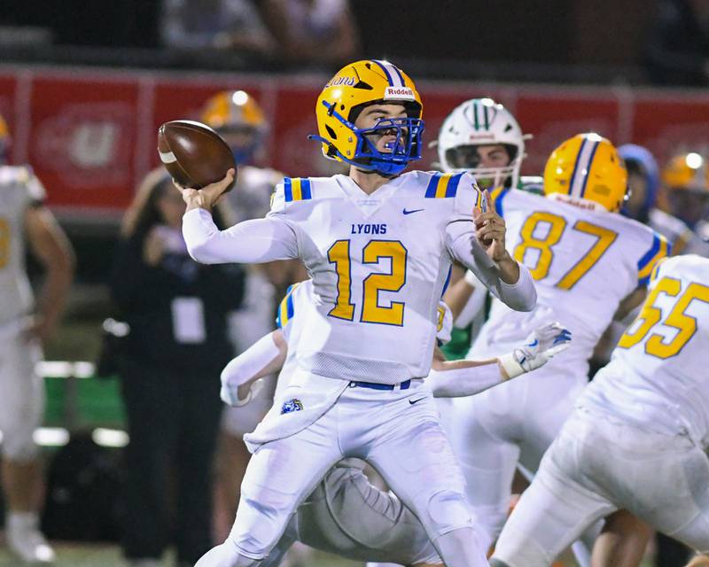 Lyons Township's Dom Pisciotti (12) passes the ball during the first quarter Friday Oct. 18, 2024, while traveling to take on York High School in Elmhurst.