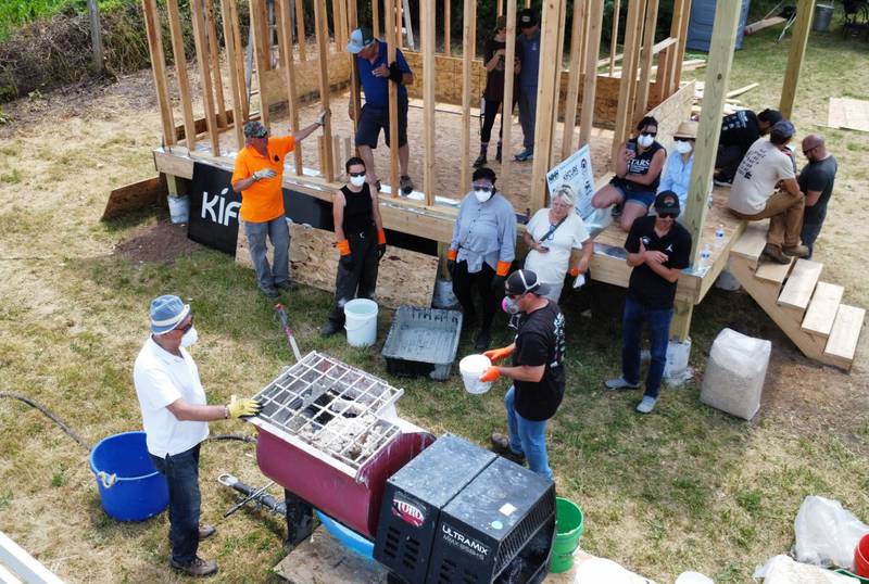 Participants in a two-day hands-on workshop June 20-21 at the Northern Illinois Hemp Hub in Maple Park are putting together the first batch of hempcrete to put into the structure. The workshop demonstrated the use of hempcrete in building materials – the first such building approved in the state.