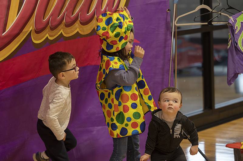 Jameson Schlemmer (left), 4, Laila, 6, and Jacob, 1, of Sterling have their picture taken Tuesday, April 2, 2024 at Dixon Park District’s The Facility during the Cirque Luz Dalia show.