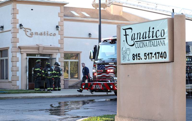 Firefighters exit the site of a structure fire Friday, Sept. 1, 2023, in the building that once housed Fanatico Italian restaurant at 1215 Blackhawk Road in DeKalb.