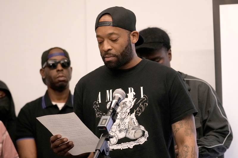 Donzell, who alleges sexual abuse while in the custody of the Illinois Department of Corrections and Department of Juvenile Justice, reads from a prepared statement as Luke Matthews, left, listens during a news conference as Donzell, left, listens Monday, June 3, 2024, in Chicago. Dozens more former youth inmates filed lawsuits Friday, seeking millions of dollars in damages for sexual abuse they allegedly endured at Illinois detention centers dating back to the late 1990s.