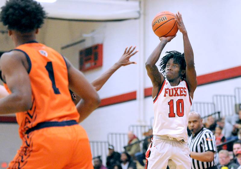 Yorkville's Kaevian Johnson (10) shoots and makes a three-point shot against Romeoville during a varsity basketball game at Yorkville High School on Friday, Jan. 19, 2024.