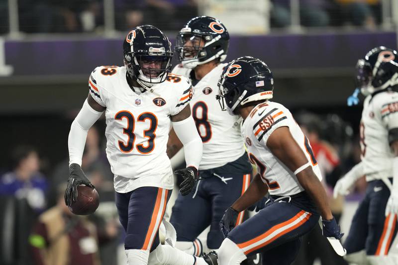 Chicago Bears cornerback Jaylon Johnson celebrates with teammates after intercepting a pass during the first half against the Minnesota Vikings, Monday, Nov. 27, 2023, in Minneapolis.