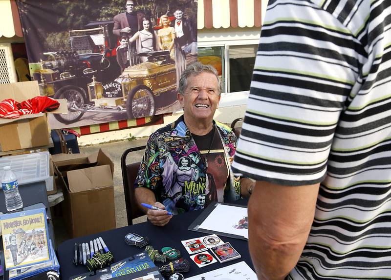 Butch Patrick, who played Eddie Munster on the 1960s show “The Munsters” signs autographs, Wednesday, Aug. 14, 2024, during an appearance at the McHenry Outdoor Theater.