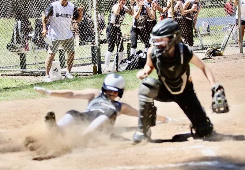 Bi-County's Chloe Parcher slides home safely in Sunday's District 20 Junior League Softball championship game at Sunset Park in Peru. Bi-County beat Mendota 14-9.