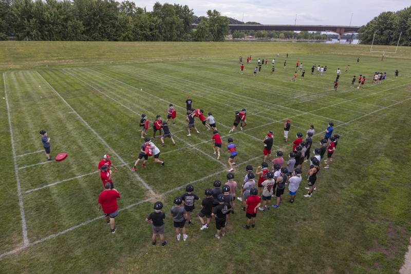 Ottawa High School football players run various drills across the field on opening practice day of football season at Ottawa High School on August 12, 2024.