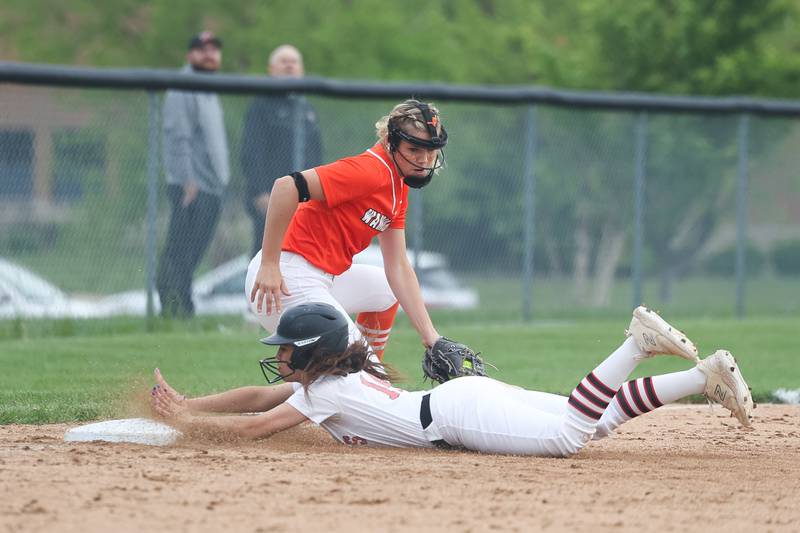 Lincoln-Way Central’s Ava Quinlan slides into third ahead of the tag by Lincoln-Way West’ Molly Finn on Tuesday, May 14, 2024 in New Lenox.