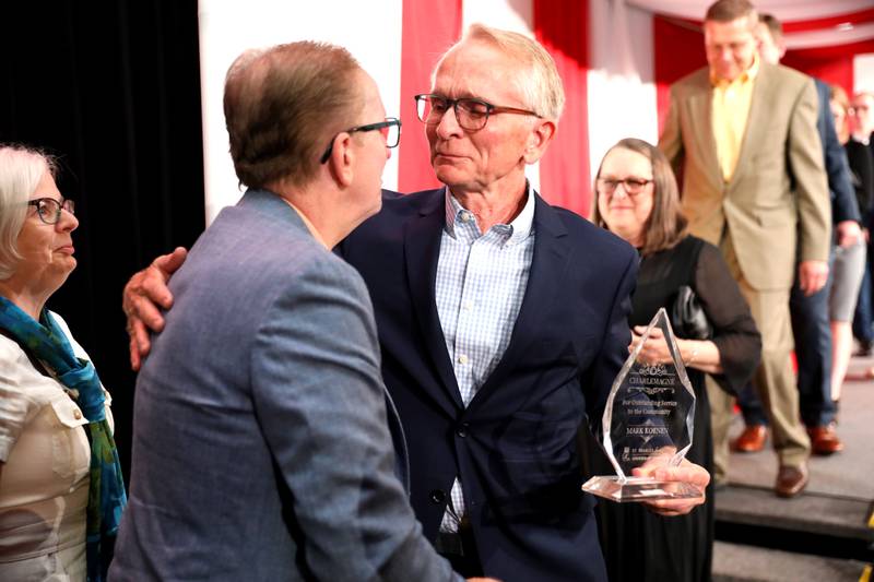 Mark Koenen, 2024 Charlemagne Award winner, greets his brother, Larry Koenen, during the 56th Annual Charlemagne Awards Dinner hosted by the St. Charles Chamber of Commerce at the Q Center in St. Charles on Friday, May 17, 2024.