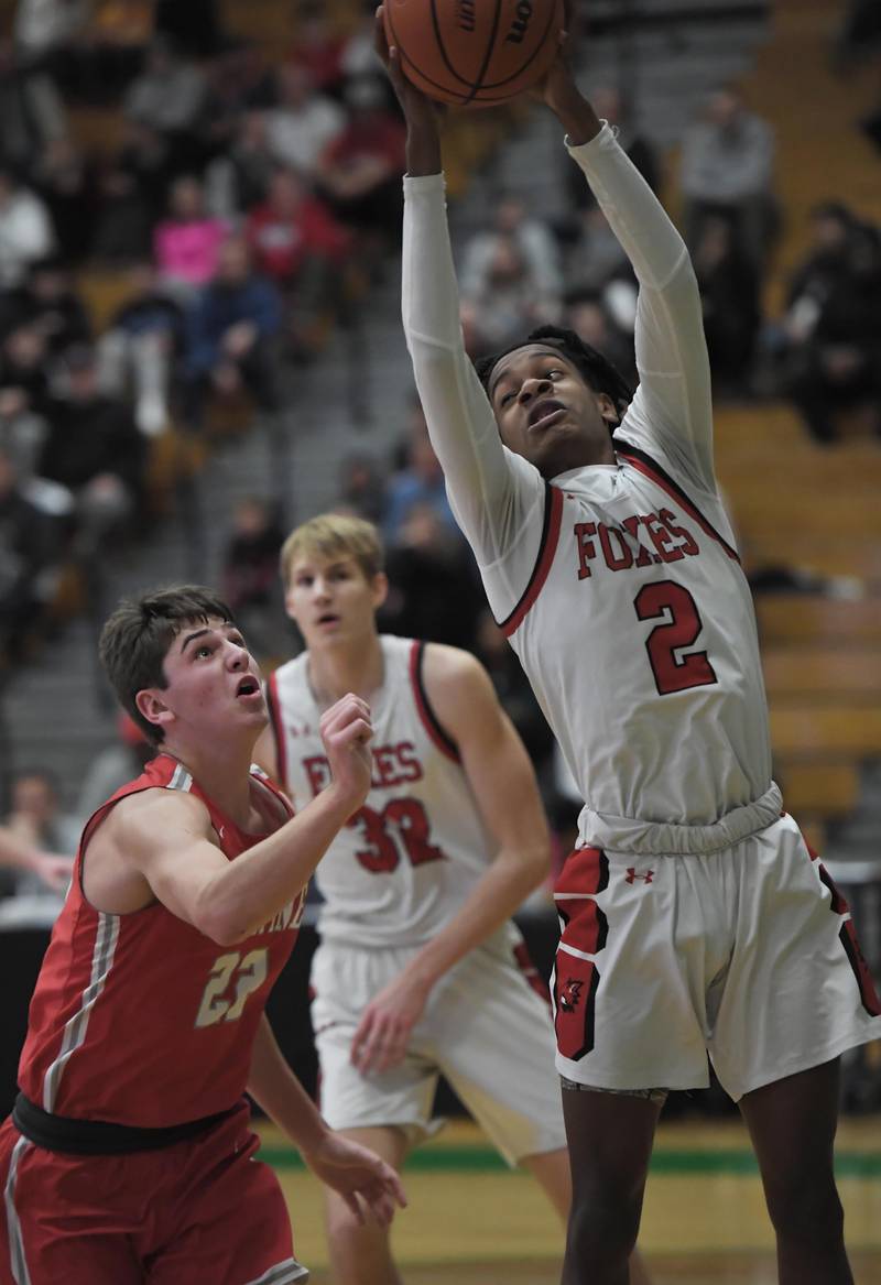 Yorkville’s Mike Dunn grabs a rebound against Palatine’s Carter Monroe in a quarterfinal game of the Jack Tosh Classic at York High School in Elmhurst on Thursday, Dec. 28, 2023.