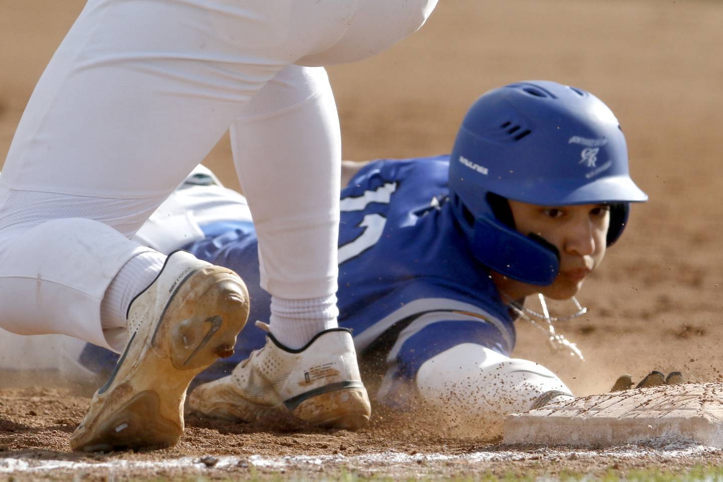 Burlington Central's Elliott Alicea dives safely back to first base during a Fox Valley Conference baseball game against Huntley on Friday, May 10, 2024, at Huntley High School.