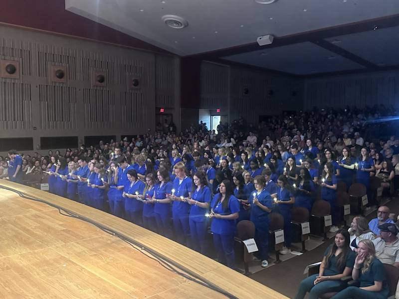 The Grundy Area Vocational Center's Class of 2024 CNAs take their pledge Wednesday night during the pinning ceremony held in the Coal City High School auditorium.