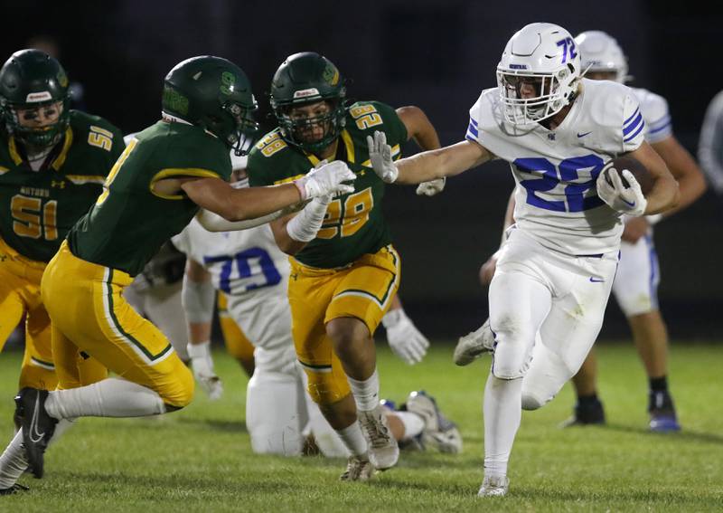 Burlington Central's Joseph Kowall runs away from the pursuit of Crystal Lake South's Jonathan Miller (left) and Crystal Lake South's Giovan Evers (center) during a Fox Valley Conference football game on Friday, Sept. 8, 2023, at Crystal Lake South High School.