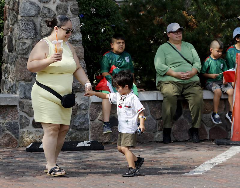 Yesenia Ibarra twirls her grandson, Ezrah Tavres, as they dance during the annual Hispanic Connections Mexican Independence Day Celebration on Sunday, Sept. 15, 2024, in the Historic Woodstock Square. The celebration featured music, food and culture.