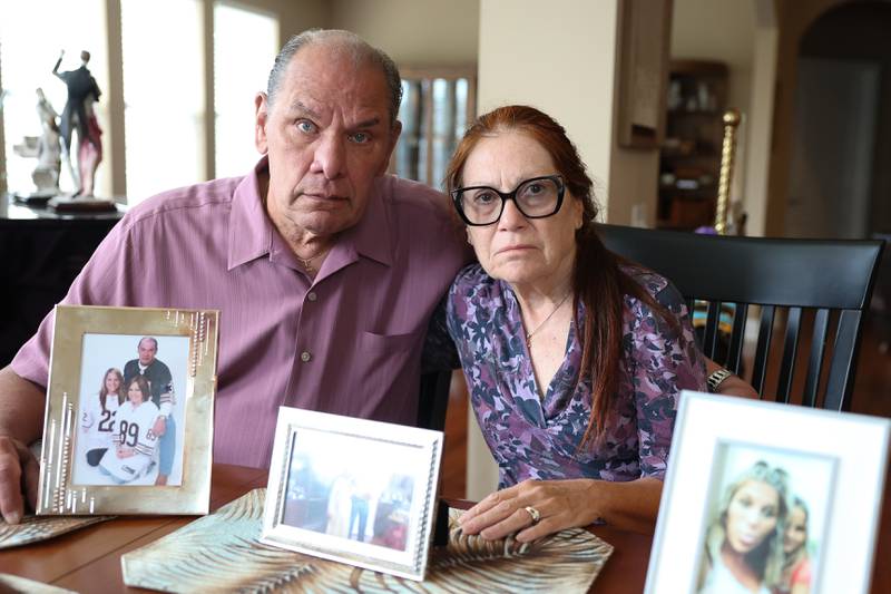 Bill and Carol May sit with photos of their daughter Melissa Aud-Headlee at their home in Shorewood on Tuesday, May 14, 2024. Melissa was murdered by her estranged husband on Saturday, May 11, who then killed himself in Joliet.