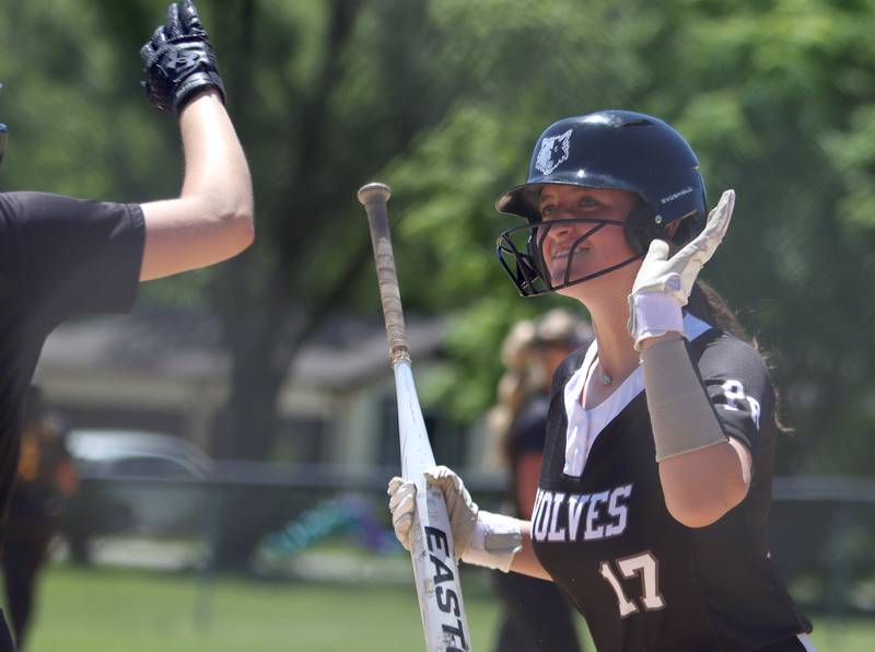 Prairie Ridge’s Parker Frey celebrates after coming around to score against Harvard during Class 3A softball regional final action at Lions Park in Harvard Saturday.