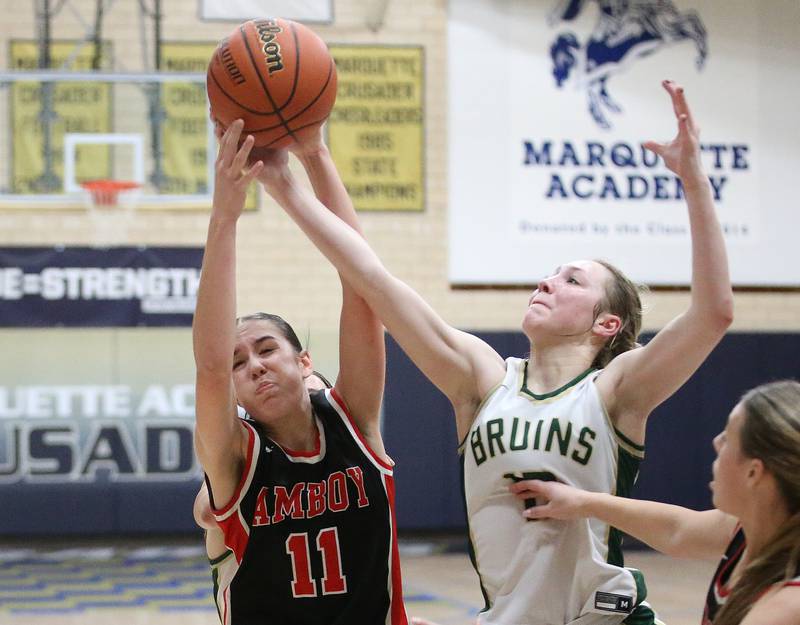 Amboy's Tyrah Vaessen and St. Bede's Ashlyn Ehm jump for a rebound during the Class 1A Regional final game on Friday, Feb. 16, 2024 at Marquette High School.