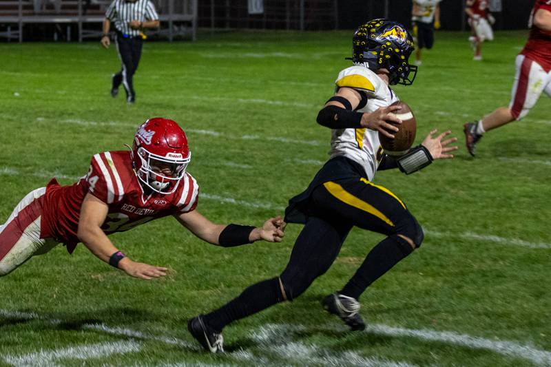 Kolton Kruse of Riverdale runs ball whilst Aiden Redcliff of Hall trails behind him on Friday, October 18, 2024 at Richard Nesti Stadium in Spring Valley.