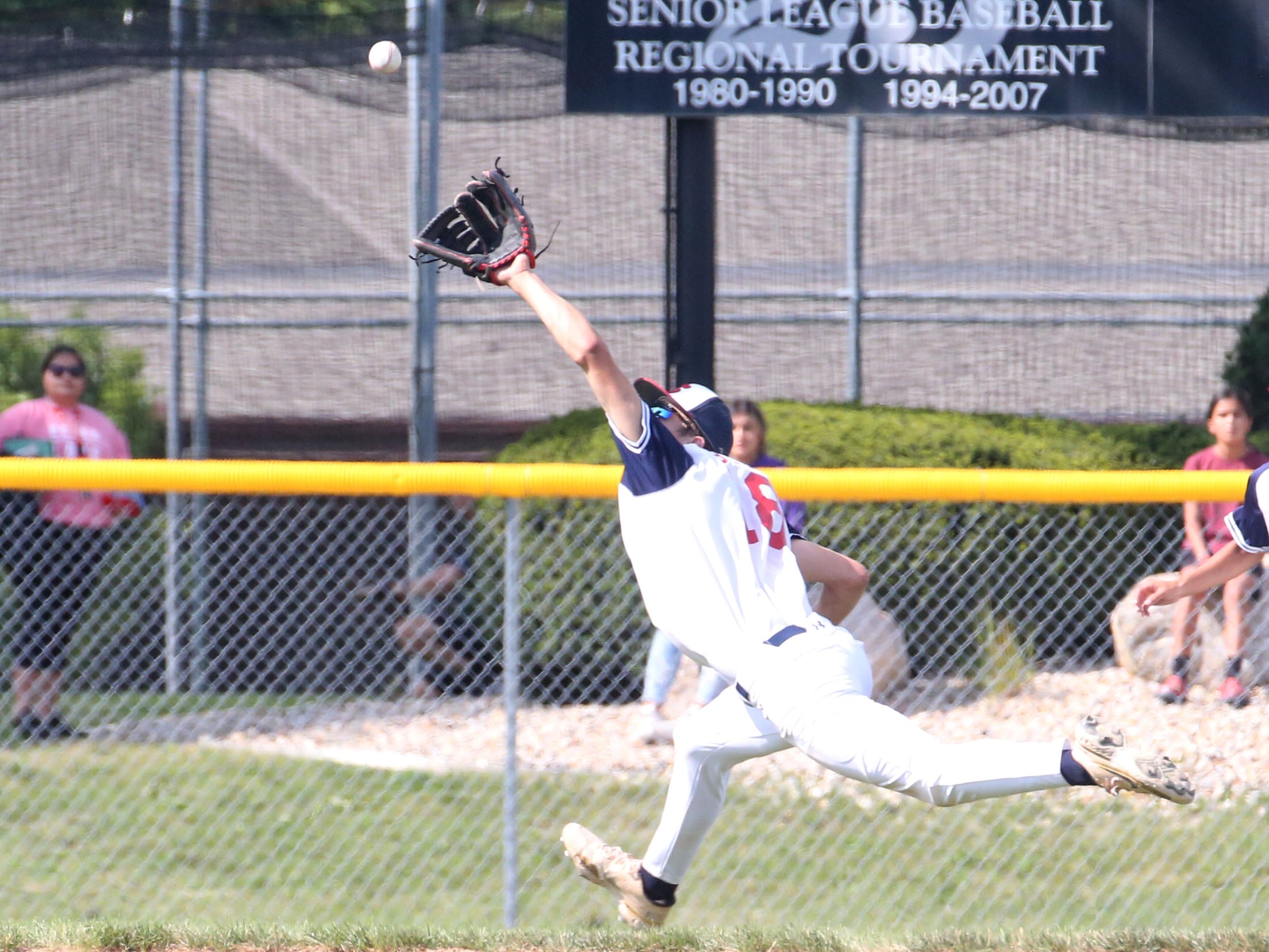 Michigan's William Bush makes a catch at short stop during the Central Regional  Baseball Tournament championship on Thursday, July 18, 2024 at J.A. Happ Field in Washington Park in Peru.