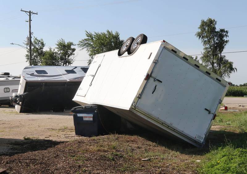 A trailer and a camper lie overturned from the storms Monday, July 15, 2024, at Cortland Coach and Camper Storage at the northeast corner of Route 38 and Somonauk Road in Cortland. High Winds and heavy storms hit DeKalb County overnight causing downed trees and power outages in the area.