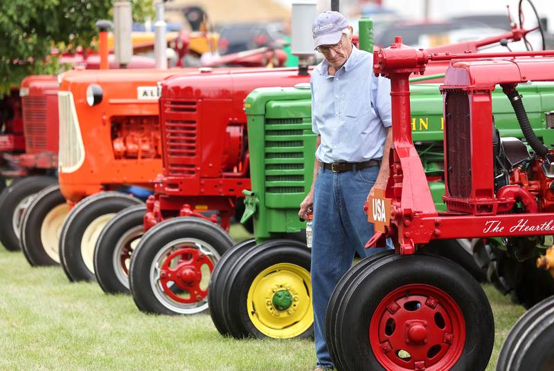 Jerry Dunham, of DeKalb, checks out some of the vintage tractors on display Saturday, July 16, 2022, at the Waterman Lions Summerfest and Antique Tractor and Truck Show at Waterman Lions Club Park.