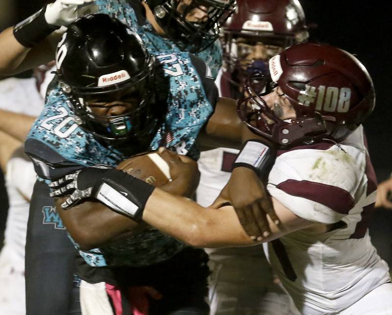 Woodstock North's David Randecker fights for extra yards as Marengo's Connor Sacco tries to tackle him during a Kishwaukee River Conference football game on Friday, Sept. 13, 2024, at Woodstock North High School.