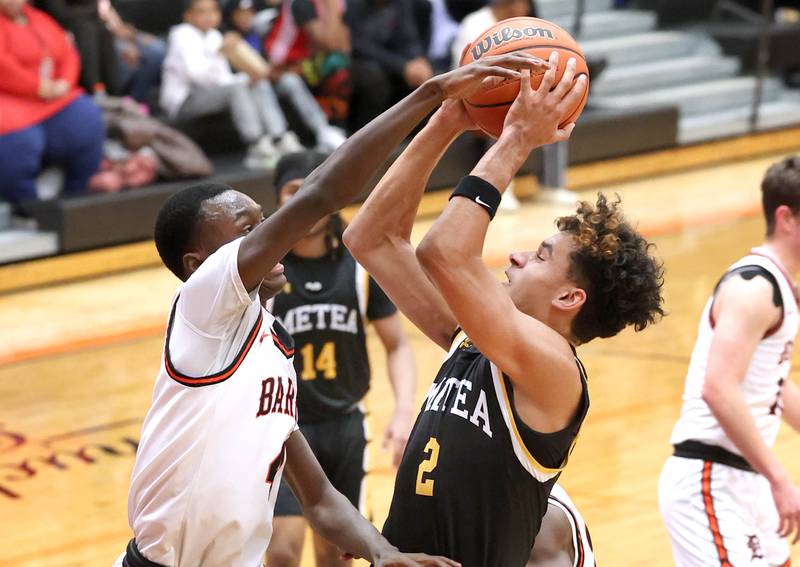 Metea Valley's Dominic Smith tries to shoot over DeKalb’s Marquise Bolden during their game Friday, Jan. 19, 2024, at DeKalb High School.