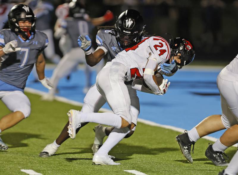 Glenbard East's Valentino Heredia (24) runs in for a touchdown during the varsity football game between Glenbard East and Willowbrook high schools on Friday, Sep. 30, 2024 in Villa Park.