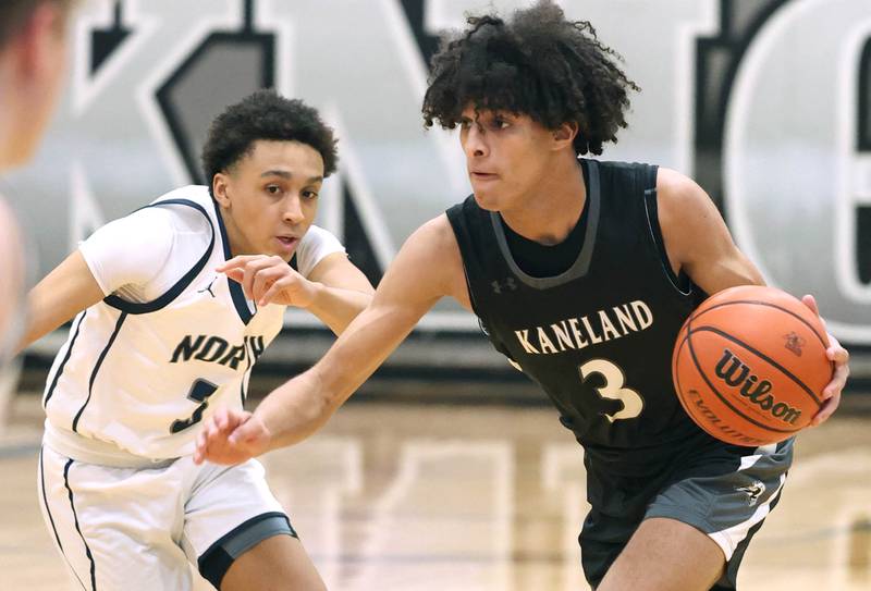 Kaneland's Evan Frieders drives by Belvidere North's Lawrence Townsend III Wednesday, Feb. 28, 2024, during their Class 3A sectional semifinal game at Kaneland High School in Maple Park.