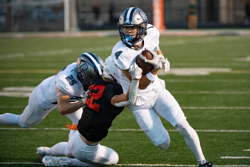 Plainfield East's Ben Haupt attempts to bring down Oswego East's Lincoln Ijams during a game on Thursday Sept. 12, 2024 at Plainfield East High School