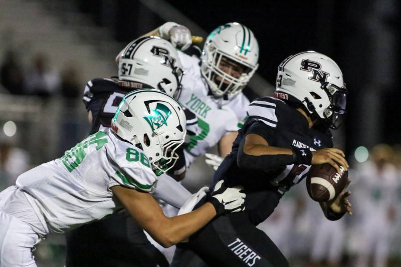 Plainfield North's Justus Byrd (13) is harassed by the York defense during a football game between York at Plainfield North on Friday, Sept 6th, 2024 in Plainfield. Gary E Duncan Sr for Shaw Local News Network.