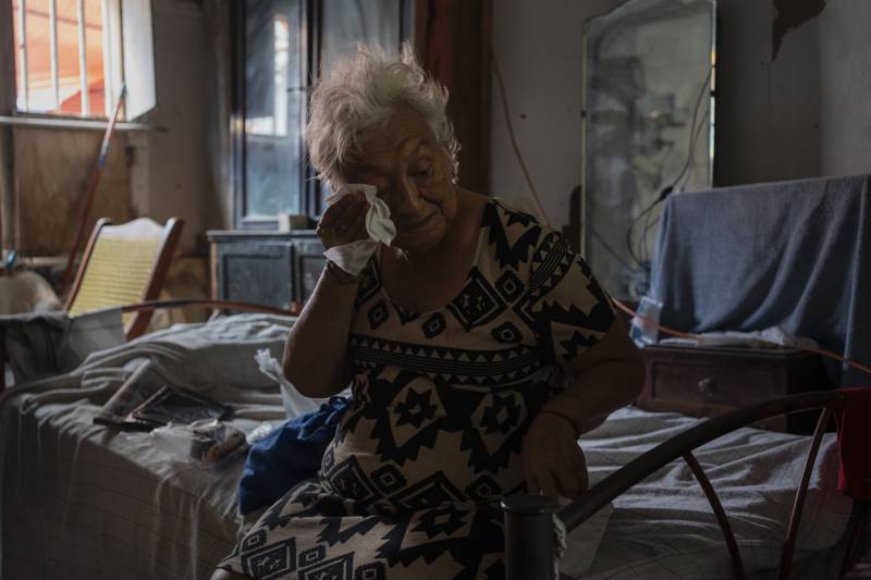 FILE - Margarita Salazar, 82, wipes the sweat off with a tissue inside her home in Veracruz, Mexico on June 16, 2024. (AP Photo/Felix Marquez, File)