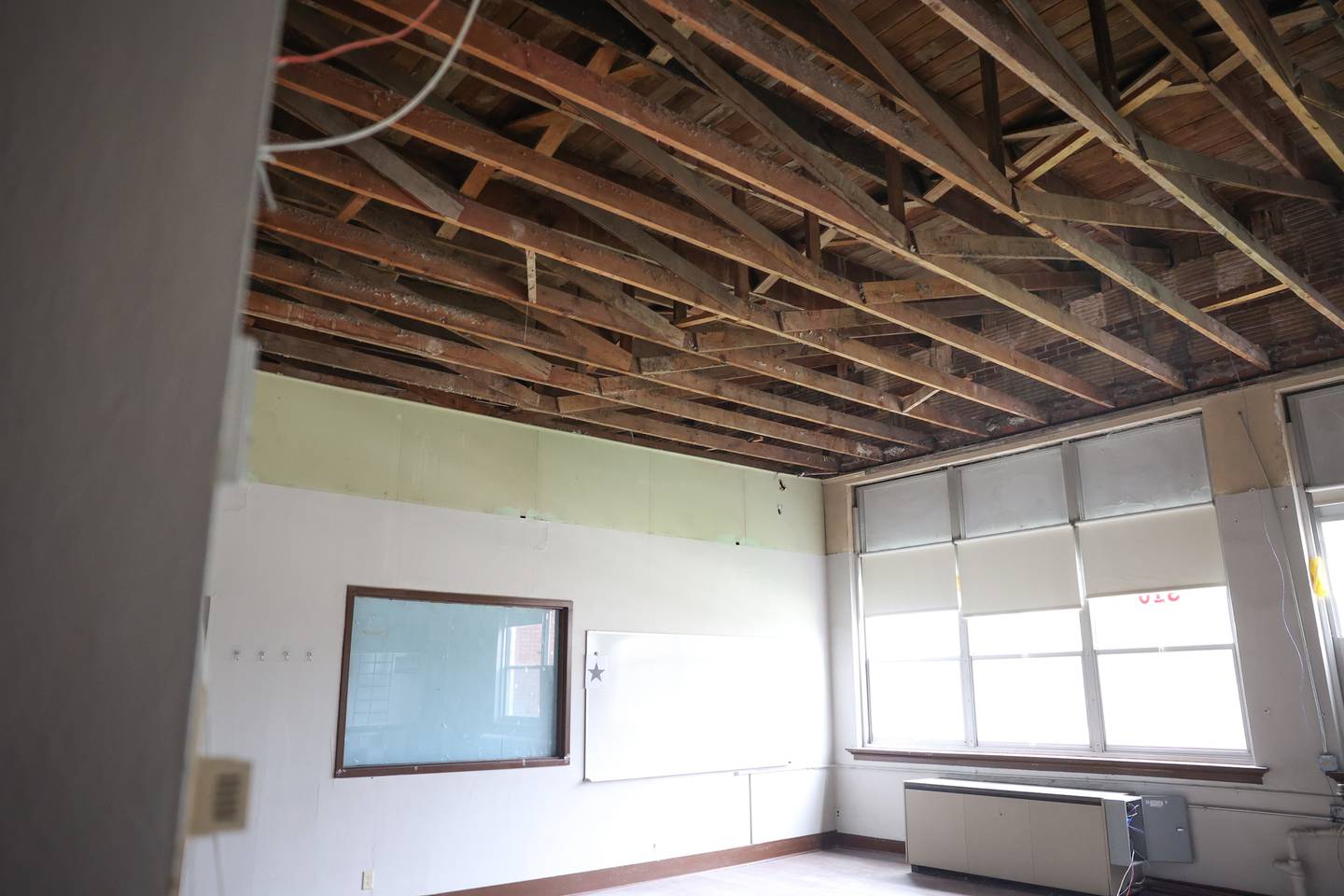 The roof of the 1932 section of the Lockport Township High School Central Campus is exposed in a classroom after the ceiling was taken down.