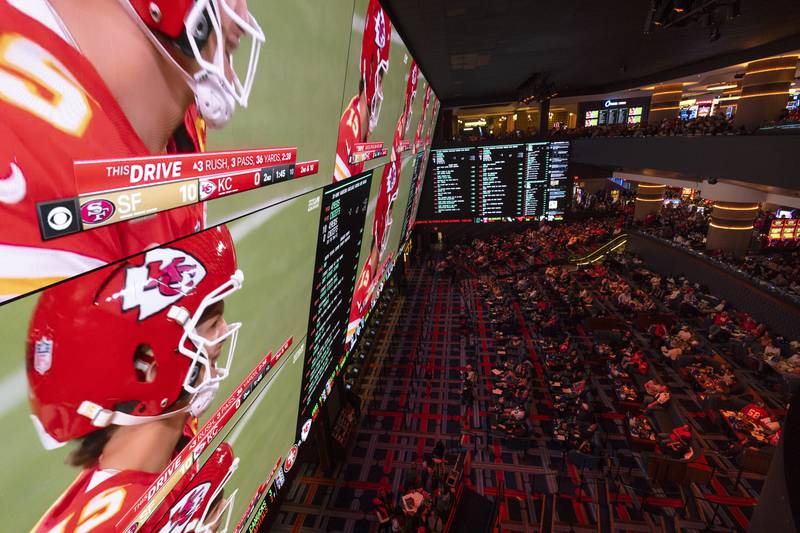 Fans watch the Super Bowl 58 NFL football game on screens at a sportsbook, Sunday, Feb. 11, 2024, in Las Vegas. (AP Photo/Gregory Bull)