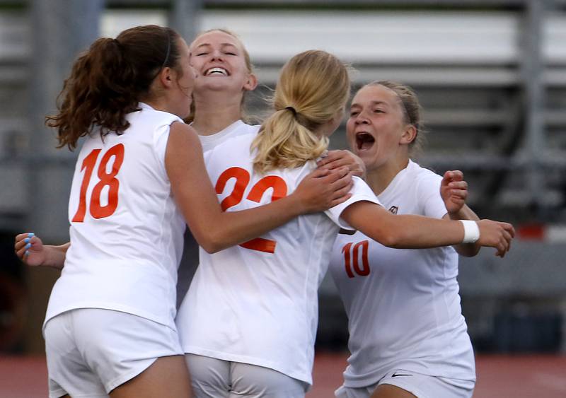Crystal Lake Central's Sadie Quinn, Maddie Gray, Brooklynn Carlson mob their teammate Olivia Anderson after she scored Crystal Lake Central first goal during the Class 2A Deerfield Supersectional girls soccer match against St. Ignatius College Prep on Tuesday, May 28, 2024, at Deerfield High School.