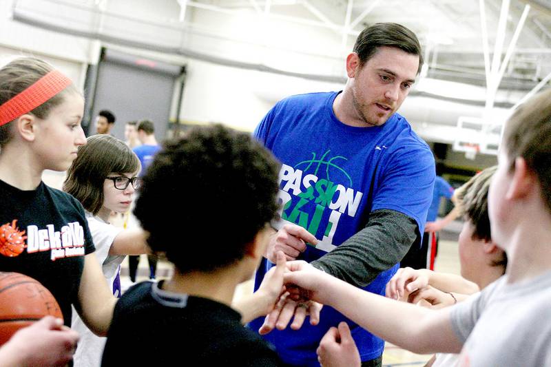 Justin Allen brings in the group of middle-school age children before switching groups during a basketball camp run by Allen at the Sycamore High School Field House on Saturday, March 28, 2015. Allen is a Malta High School alum and played basketball for Arizona State University. He was a national comeback player of the year in 2004 for coming back from Hodgkin's Lymphoma.