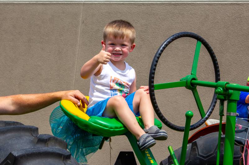 Maverick Johnson sits in driver seat of tractor on Saturday, July 20, 2024 at the Convoy Against Cancer Big Truck Show on Main Avenue in Ladd.