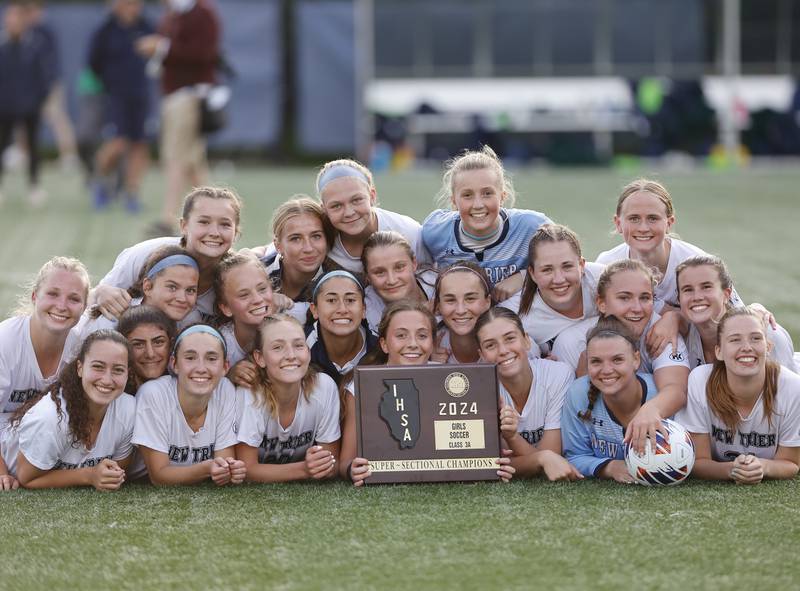 New Trier celebrates winning the Class 3A Dominican super-sectional against Lyons Township in River Forest on Tuesday, May 28, 2024.