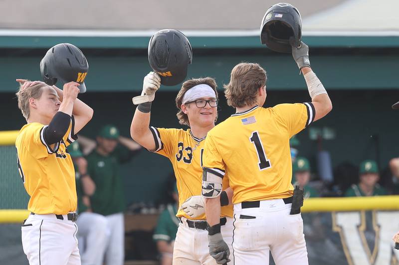 Joliet West’s Owen Young (33) is greeted at home plate after his two-run home run against Plainfield Central on Thursday, May 16, 2024, in Plainfield.