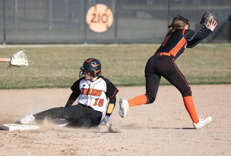 Sandwich's Johanna Freemon slides in safely to second as DeKalb's Hazel Montavon comes off the bag to catch the throw during their game Tuesday, March 19, 2024, at DeKalb High School.