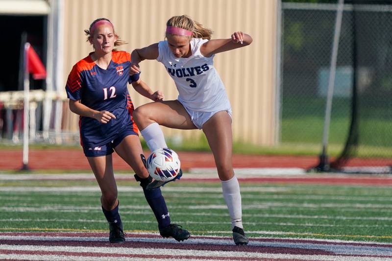 Oswego East's Anya Gulbrandsen (3) plays the ball against Oswego’s Ainsley Barnes (12) during a Class 3A Lockport Regional semifinal soccer match at Lockport High School in Lockport on Wednesday, May 15, 2024.