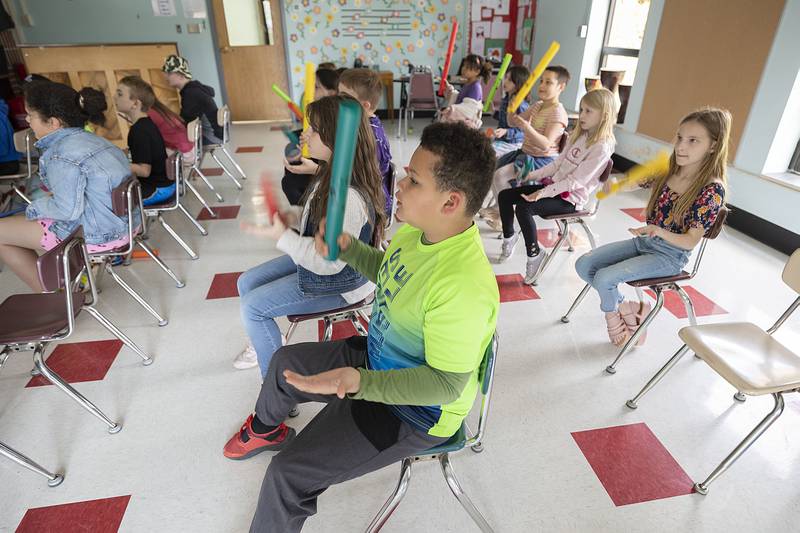 Students follow along a video that shows when each color Boomwhacker should be played.