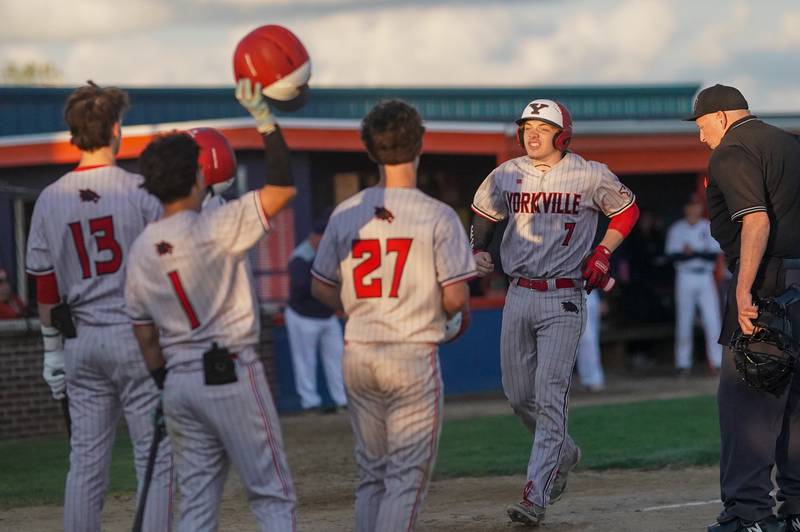 Yorkville's Joseph Onasch (7) is greeted at home after hitting a two run homer against Oswego during a baseball game at Oswego High School on Monday, April 29, 2024.