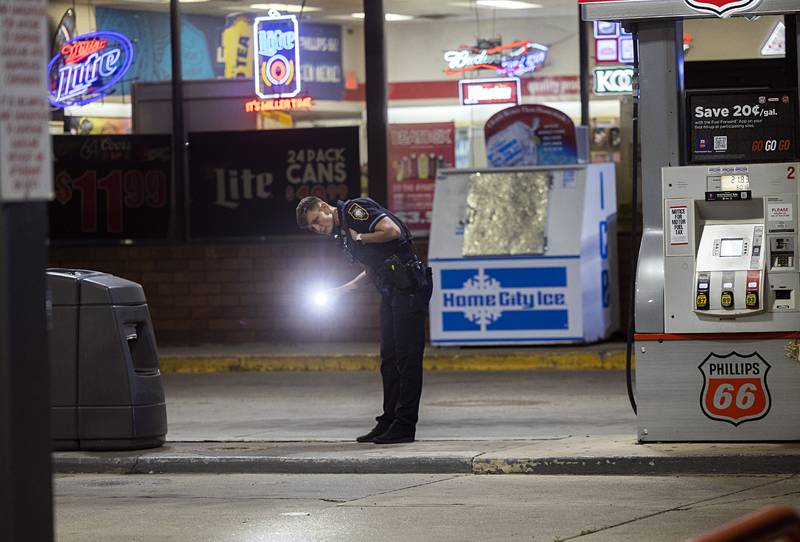 Sterling officer Jamie Russell investigates the scene of a shooting Tuesday, May 28, 2024, in the 2200 block of East Lincolnway in Sterling.