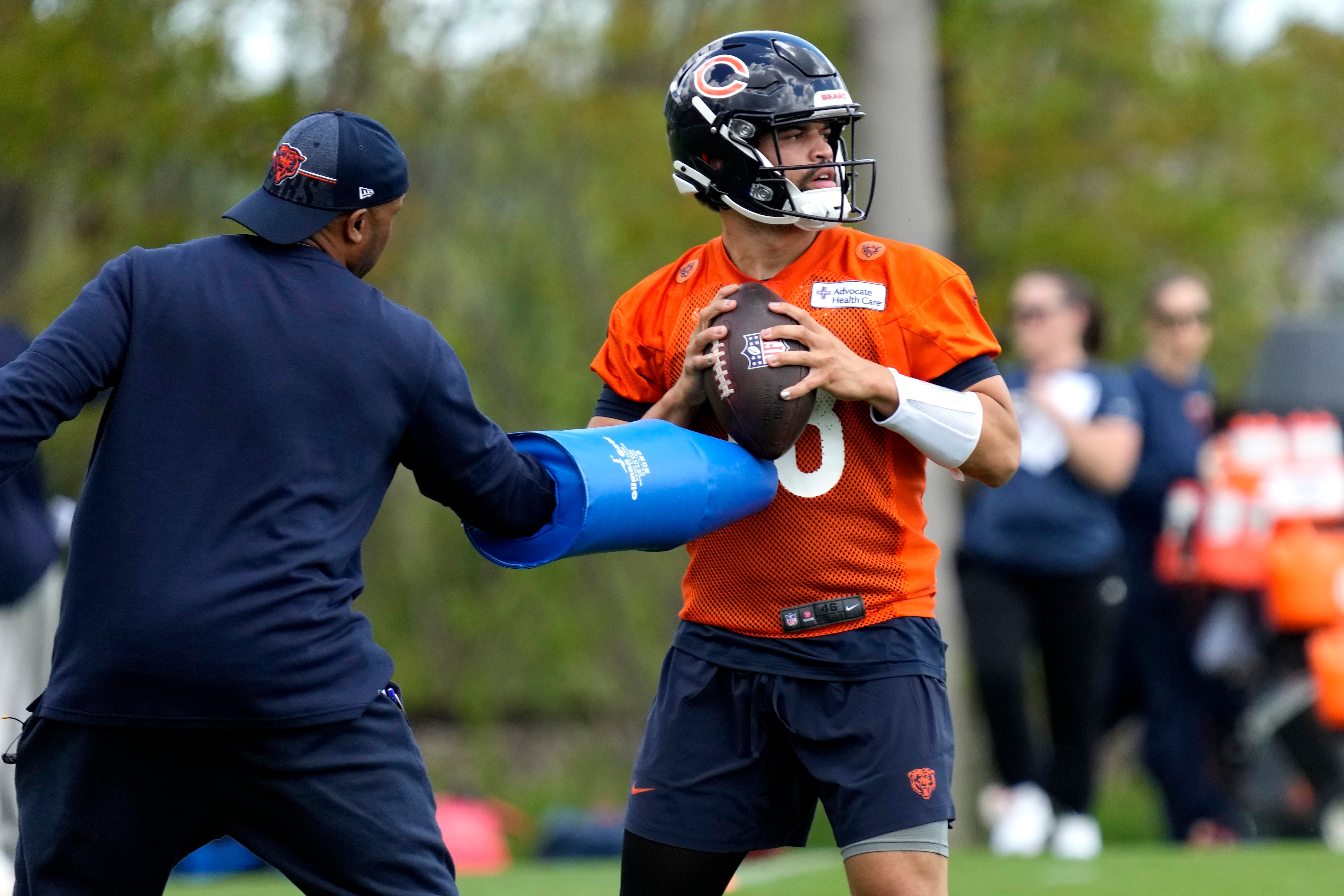 Chicago Bears quarterback Caleb Williams, right, works with a coach during the NFL football team's rookie camp earlier this month at Halas Hall in Lake Forest, Ill.