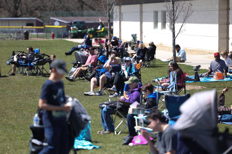 Hundres of people gathered on the lawn outside the JJC campus to view the eclipse at the Joliet Junior College solar eclipse viewing event on Monday, April 8, 2024 in Joliet.
