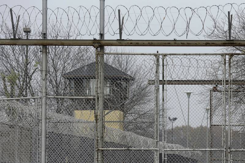 FILE - Security fences surround the Illinois Department of Corrections' Logan Correctional Center, Nov. 18, 2016, in Lincoln, Ill. Illinois Gov. J.B. Pritzker's administration has retained a contentious choice for providing medical care to prison inmates, awarding Wexford Health Sources a 10-year, $4.16 billion contract despite high vacancy rates, complaints of substandard care and lawmakers' agitation to find a replacement. (AP Photo/Seth Perlman, File)