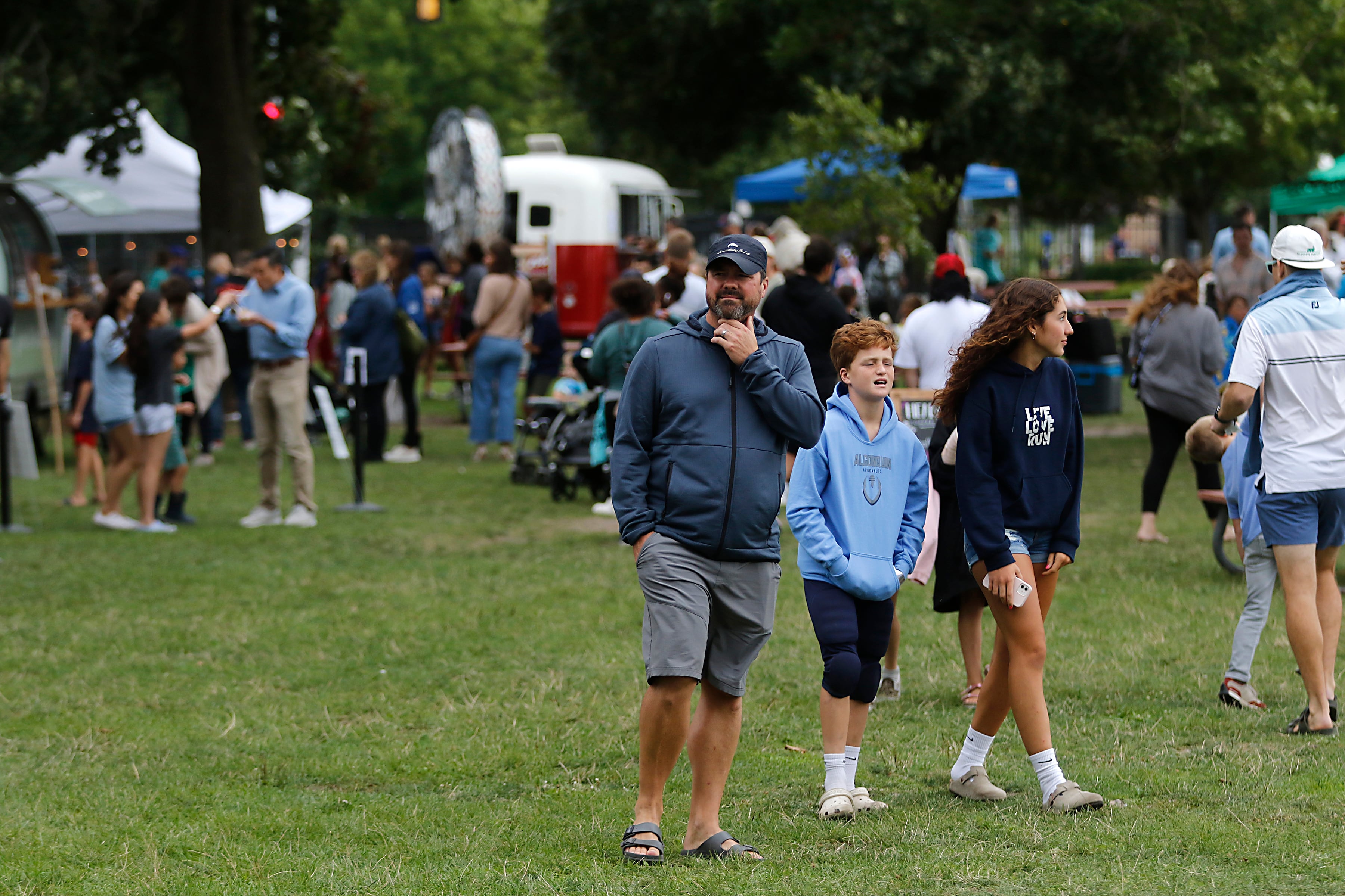 People walk around the Ice Cream Fest on Friday, Aug. 9, 2024, at Crystal Lake’s Main Beach.  The second annual event featured music, ice cream venders and an ice cream eating contest.